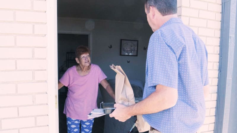 lady receiving food from volunteer